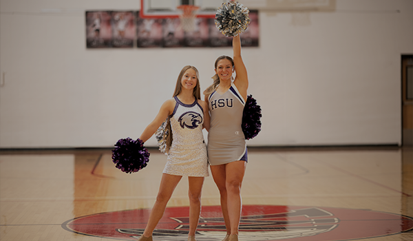 Cheerleaders wearing Champion Cheer Collegiate uniforms
