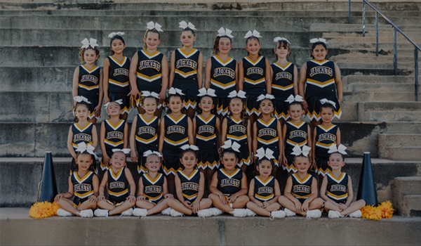 Youth cheer team wearing Champion Cheer Youth uniforms