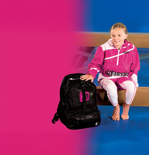 Female and male wearing Champion Gymnastics outerwear and carrying one duffle bag