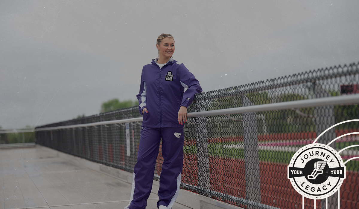Male Wearing Champion Track Warm-Ups and carrying duffle bag