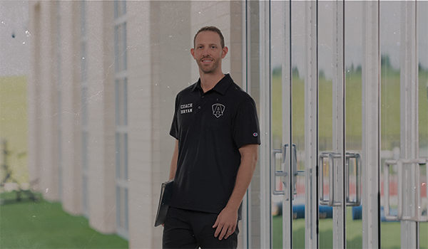 Male Wearing Champion Track Coaches Gear
