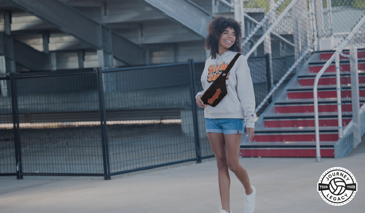 Female Wearing Champion Fan Gear and Carrying Champion Fanny Pack