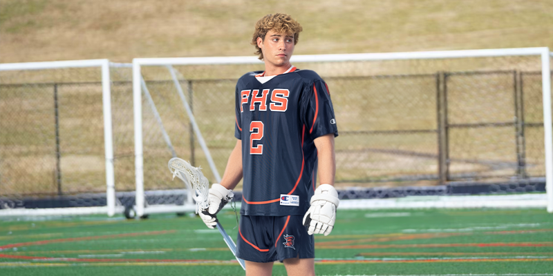 Male wearing Champion Lacrosse custom uniform